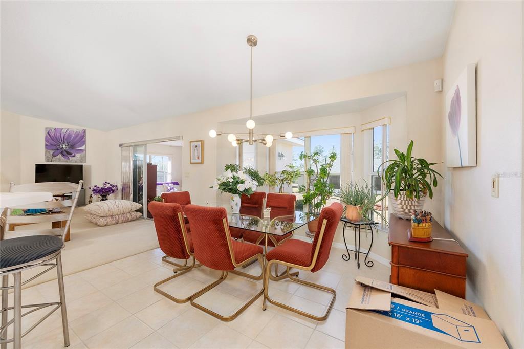 4670 Southwest 158th St Road Ocala, FL 34473 - Photo 9 of 42 a living room with furniture a chandelier and a flat screen tv