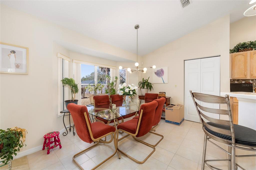 4670 Southwest 158th St Road Ocala, FL 34473 - Photo 10 of 42 a dining room with furniture a rug and a chandelier