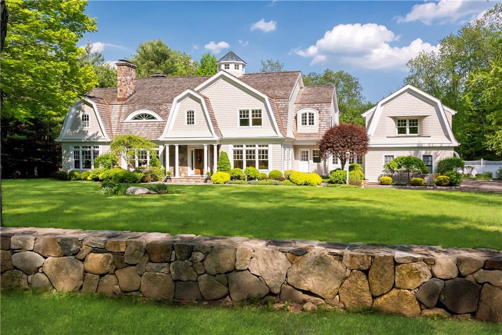 160 Silver Spring Road Ridgefield, CT 06877 - Photo 1 of 1 a front view of a house with a garden and trees
