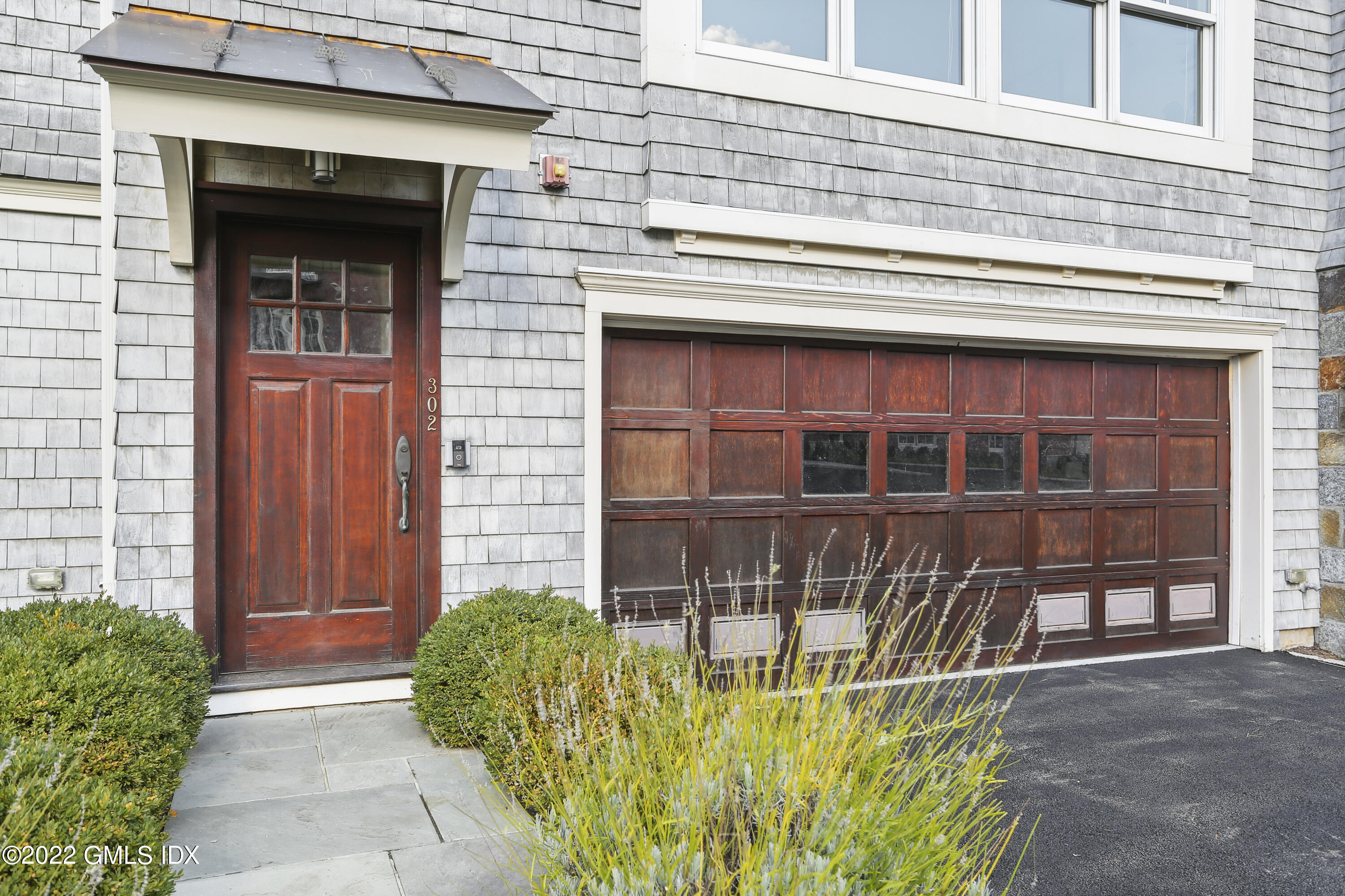 88 South Water Street, Unit 302 Greenwich, CT 06830 - Photo 15 of 21 a front view of a house with a yard and garage