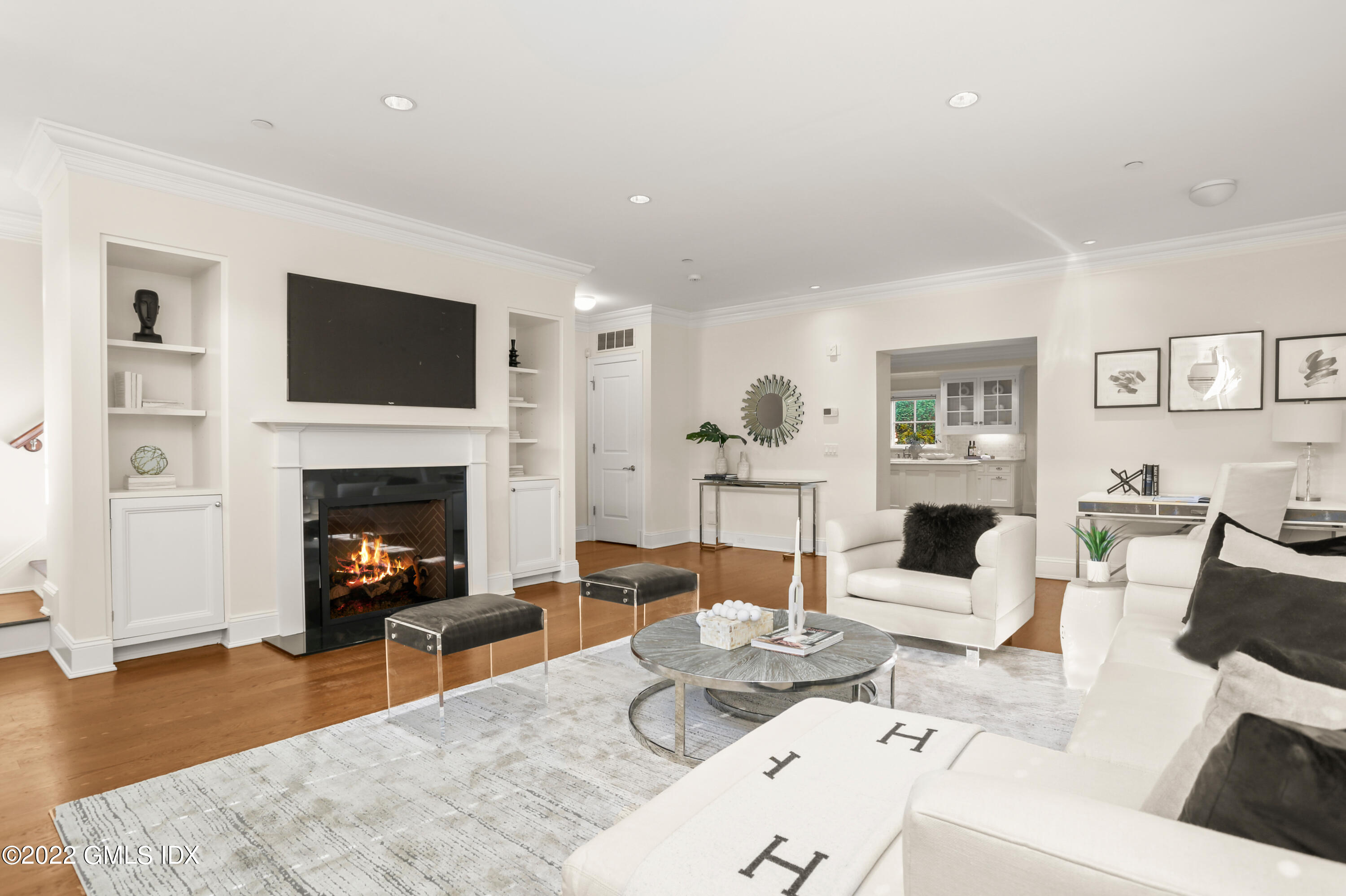 88 South Water Street, Unit 302 Greenwich, CT 06830 - Photo 2 of 21 a living room with furniture a fireplace and a flat screen tv
