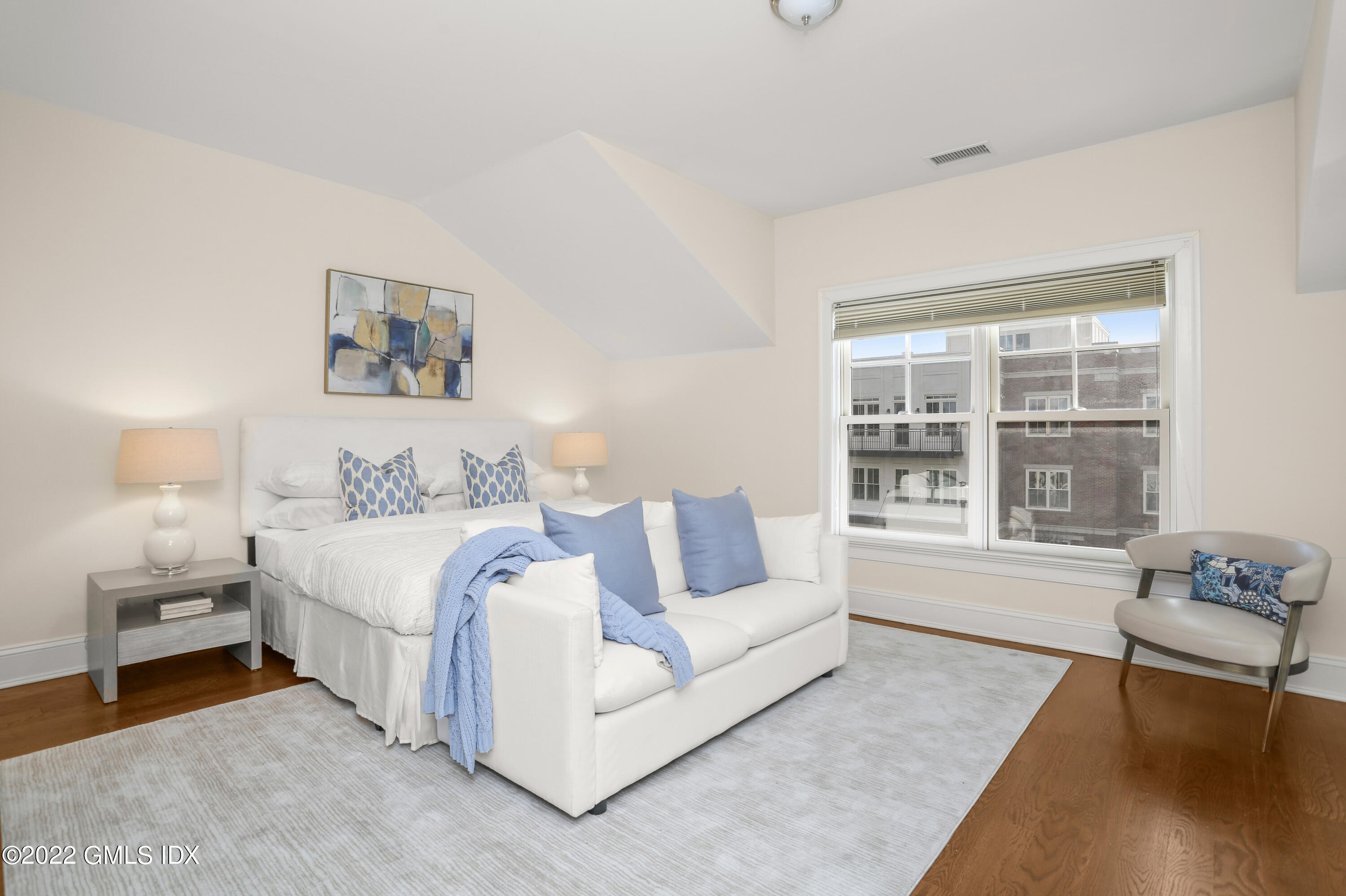 88 South Water Street, Unit 302 Greenwich, CT 06830 - Photo 10 of 21 a spacious bedroom with a bed and a window