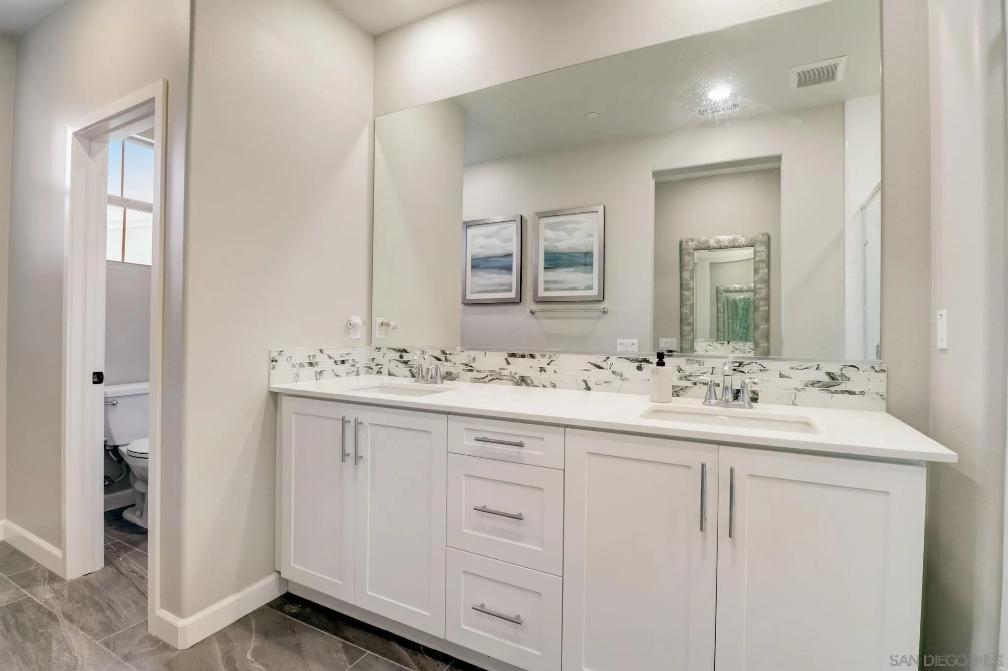 1206 Delpy View Point Vista, CA 92084 - Photo 16 of 29 a bathroom with double sink and a mirror