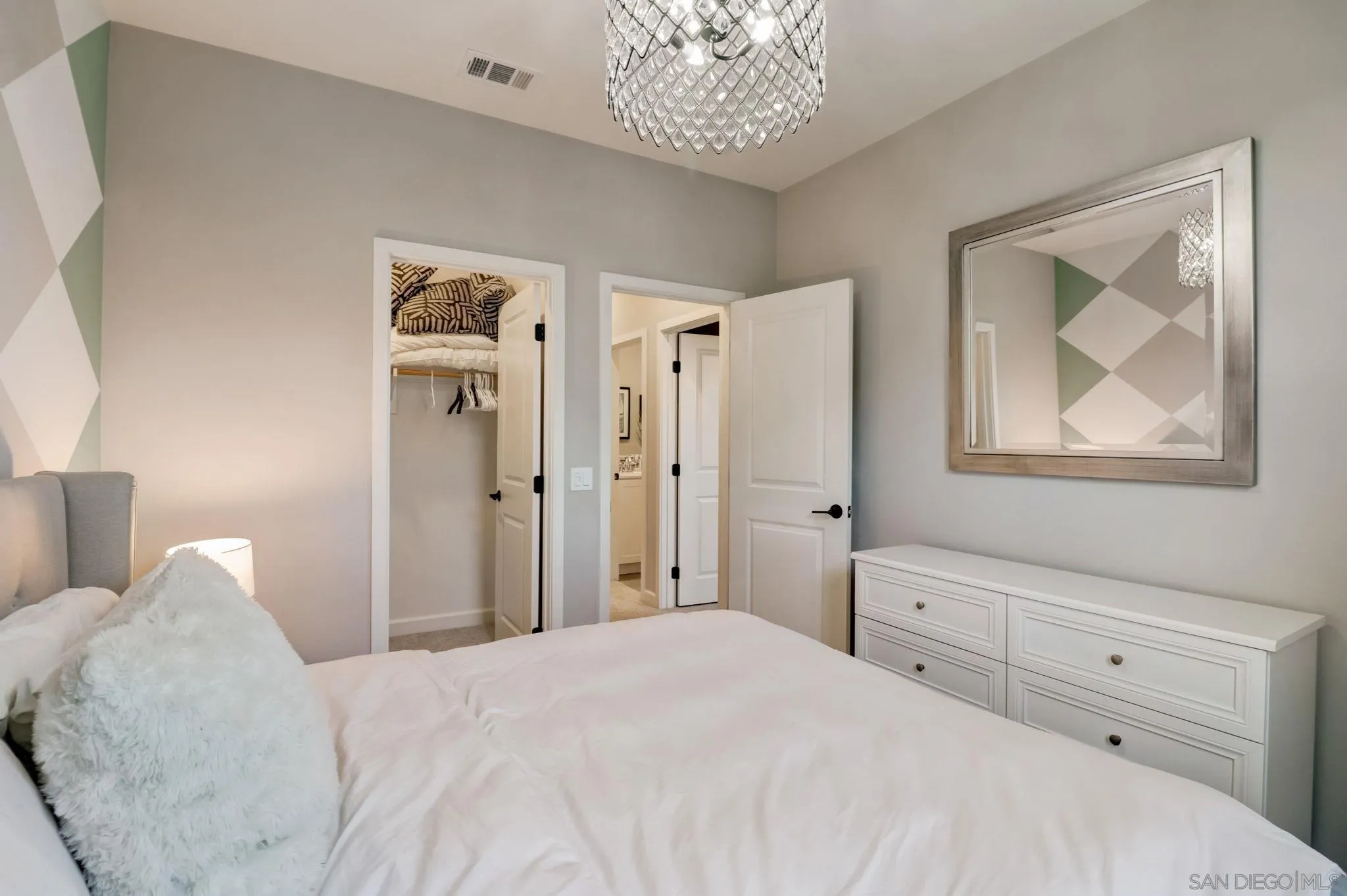 1206 Delpy View Point Vista, CA 92084 - Photo 22 of 29 a bedroom with a bed and a chandelier