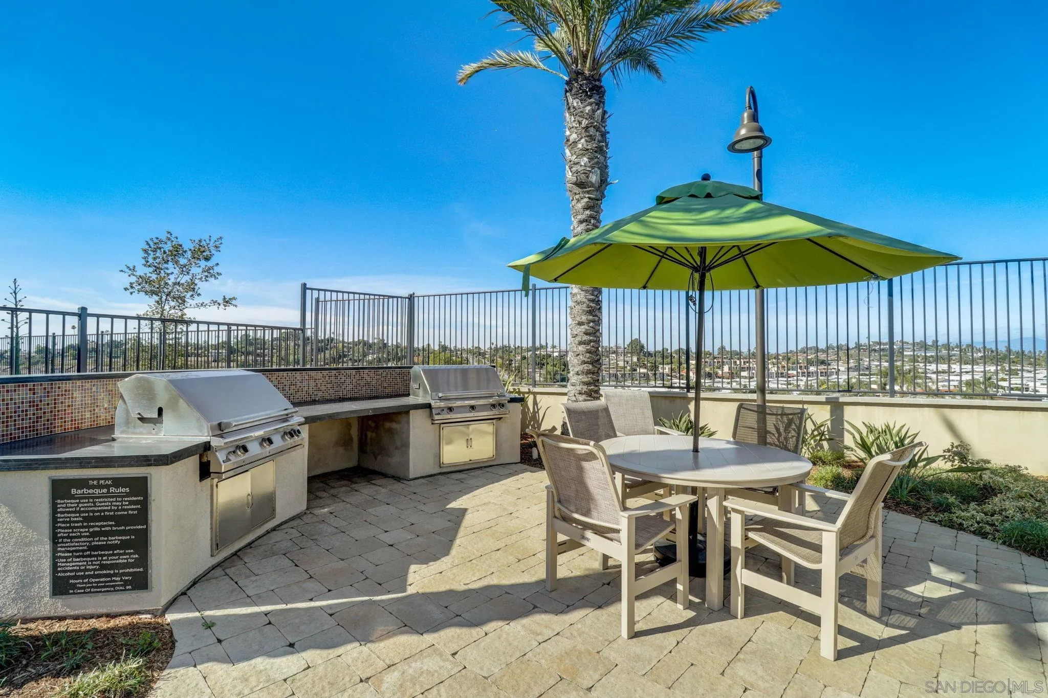 1206 Delpy View Point Vista, CA 92084 - Photo 24 of 29 a patio with a table and chairs under an umbrella