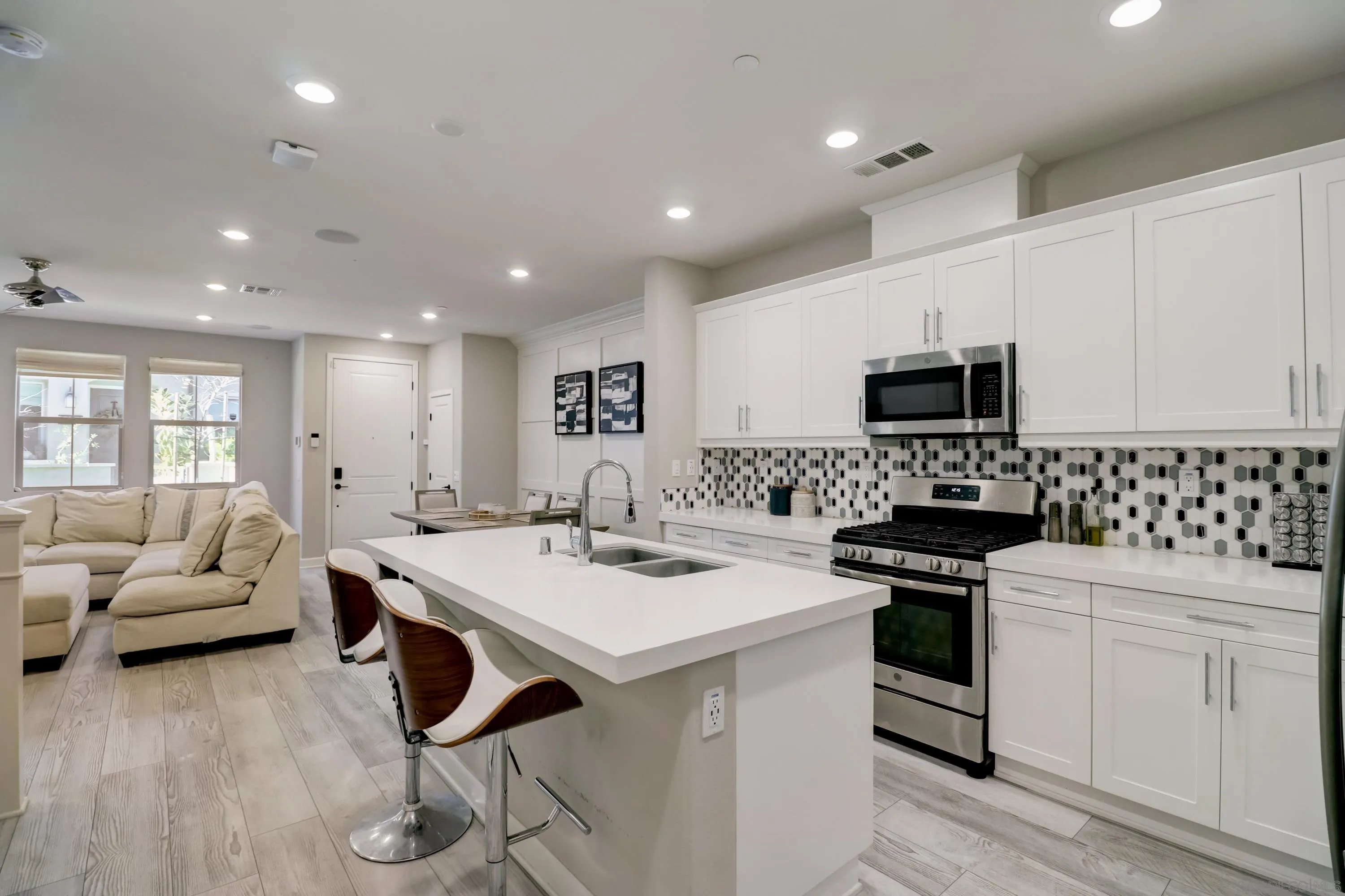 1206 Delpy View Point Vista, CA 92084 - Photo 9 of 29 a kitchen with white cabinets and appliances