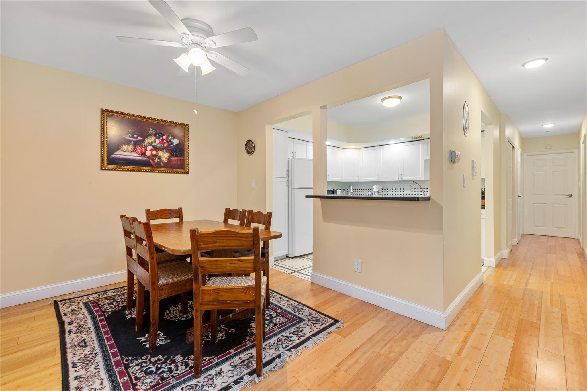 71-09 Sutton Place, Unit 2 Queens, NY 11365 - Photo 12 of 20 Dining area with baseboards, ceiling fan, and light wood-style flooring