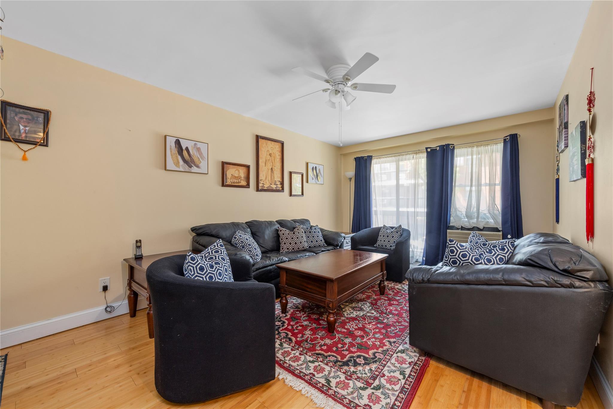 71-09 Sutton Place, Unit 2 Queens, NY 11365 - Photo 2 of 20 Living area featuring baseboards, ceiling fan, and wood finished floors