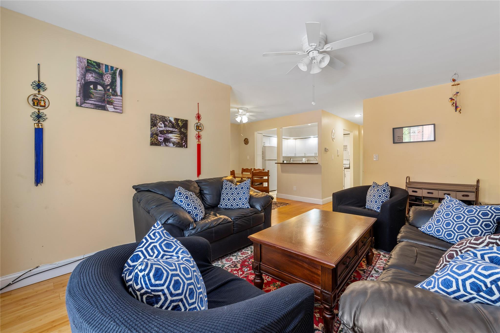 71-09 Sutton Place, Unit 2 Queens, NY 11365 - Photo 3 of 20 Living area featuring ceiling fan, baseboards, and light wood-style floors