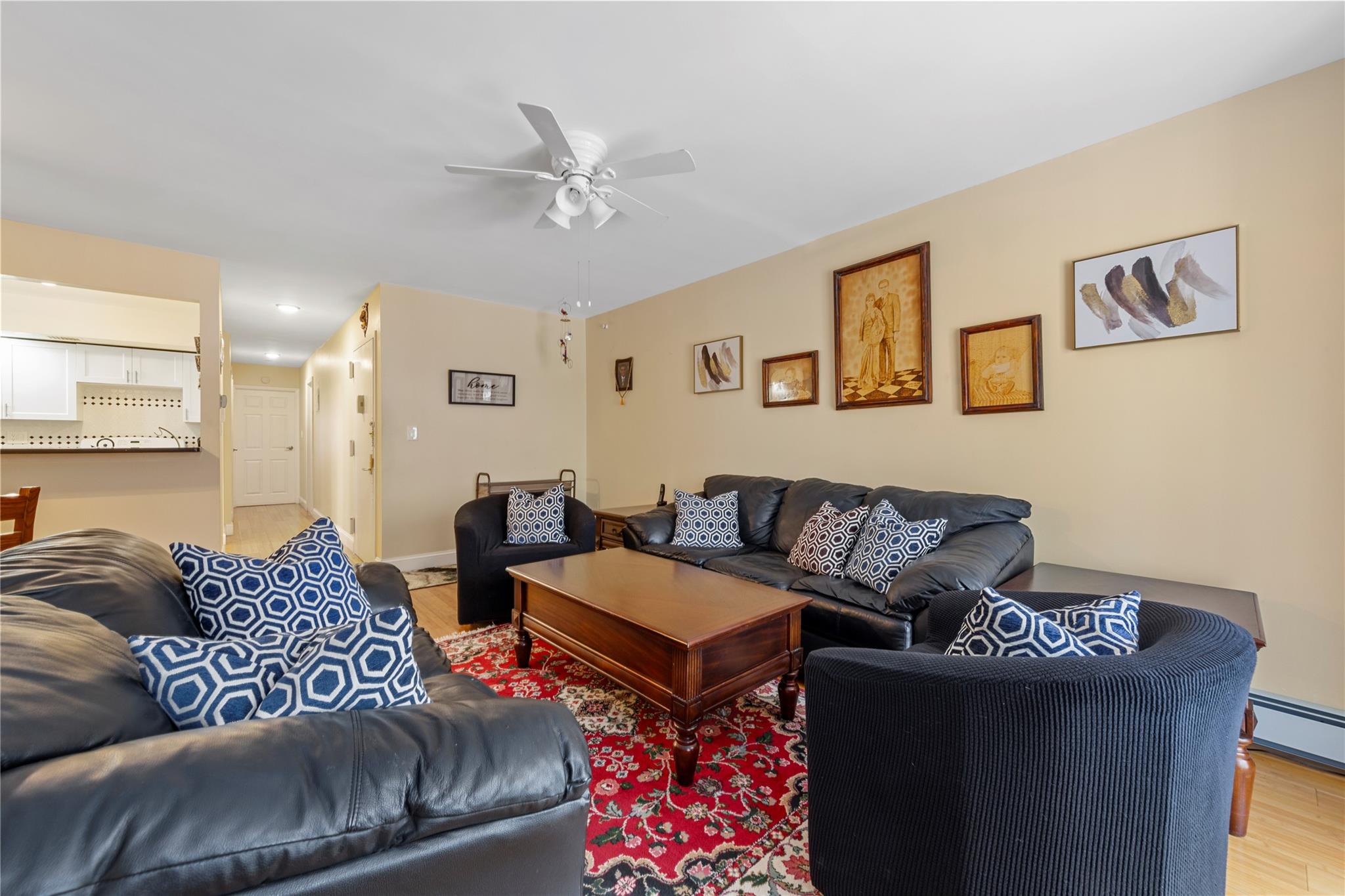 71-09 Sutton Place, Unit 2 Queens, NY 11365 - Photo 4 of 20 Living room featuring ceiling fan, light wood-style flooring, and a baseboard radiator