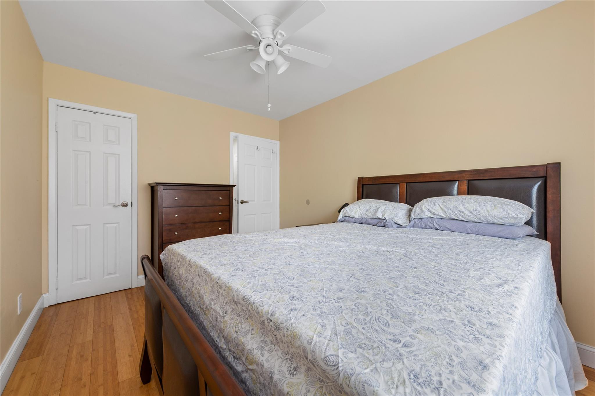 71-09 Sutton Place, Unit 2 Queens, NY 11365 - Photo 6 of 20 Bedroom with light wood-type flooring, a ceiling fan, and baseboards
