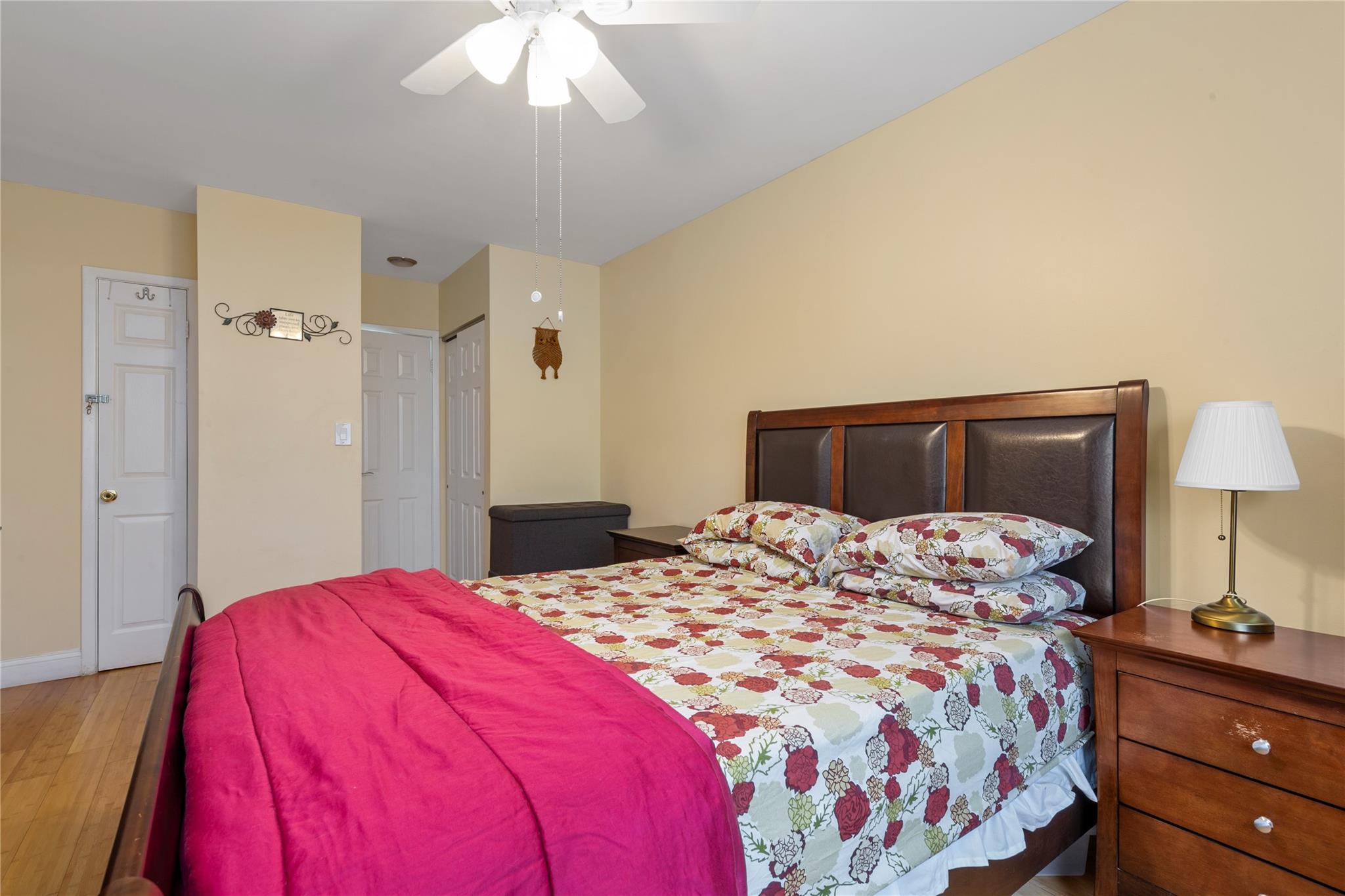 71-09 Sutton Place, Unit 2 Queens, NY 11365 - Photo 8 of 20 Bedroom featuring a ceiling fan and wood finished floors