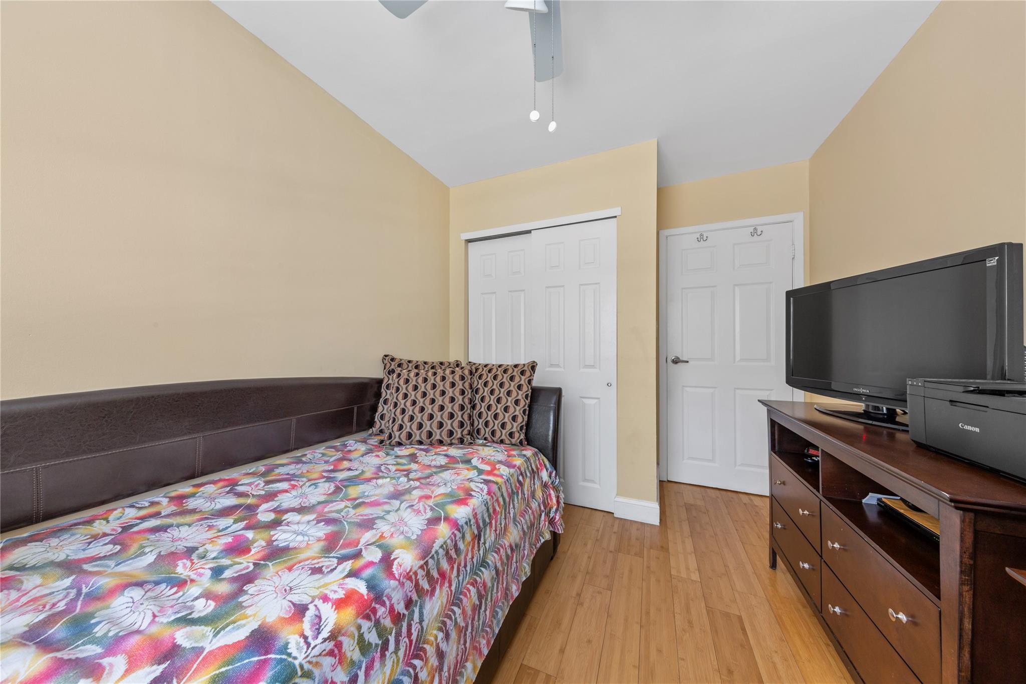 71-09 Sutton Place, Unit 2 Queens, NY 11365 - Photo 10 of 20 Bedroom featuring a closet, a ceiling fan, light wood finished floors, and lofted ceiling