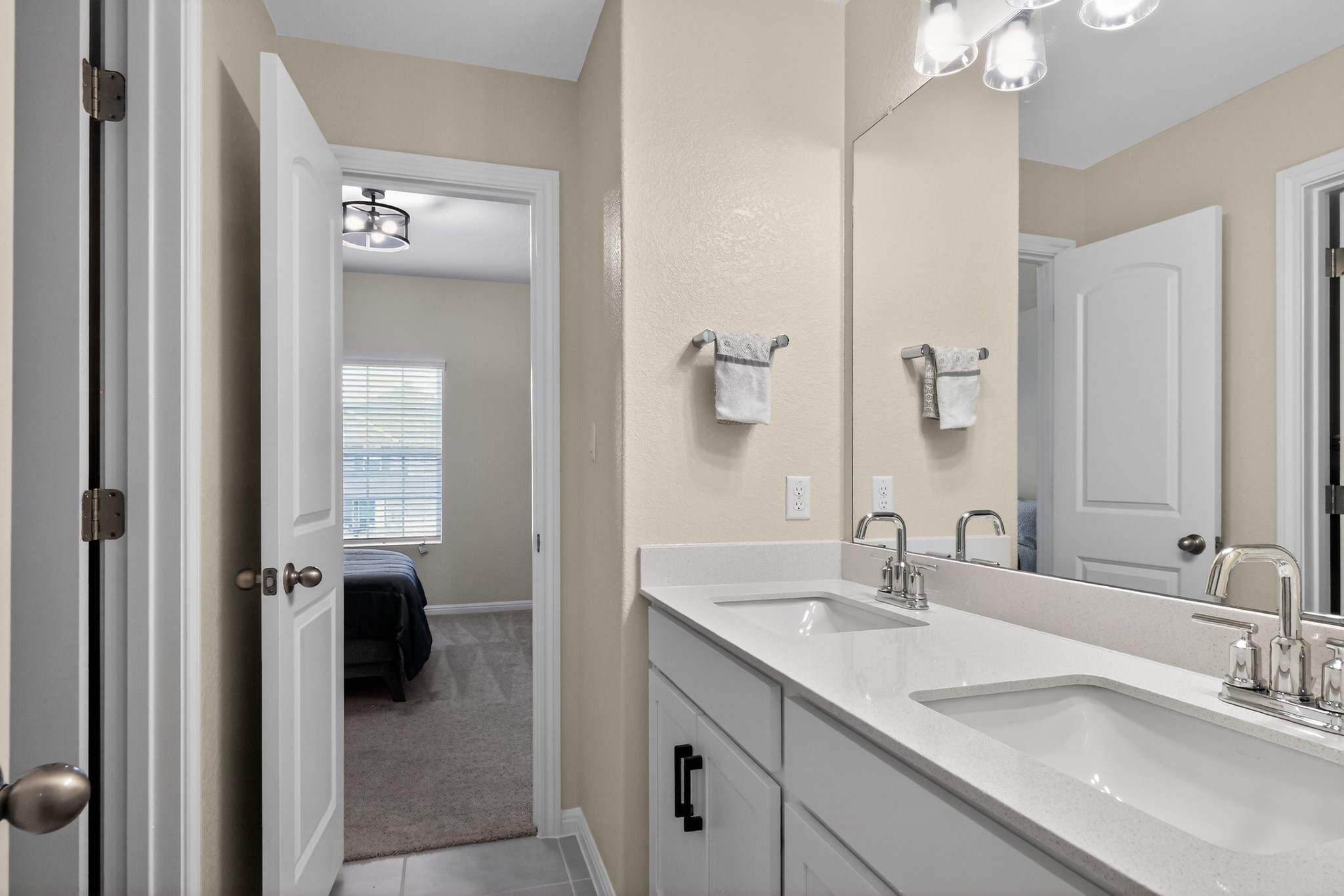 114 Bosco Road Hutto, TX 78634 - Photo 22 of 39 Double vanity with sleek countertops offers practical elegance in this private bathroom.
