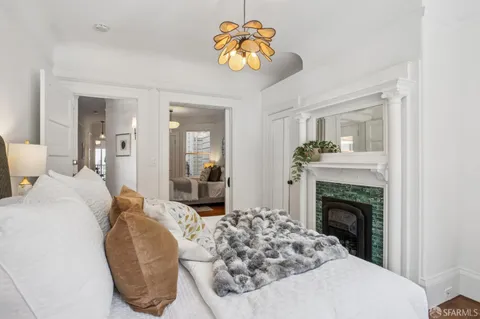 a bedroom with a bed and a chandelier
