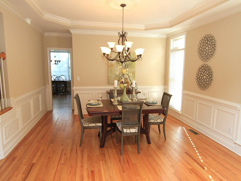 12308 Canolder Street Raleigh, NC 27614 - Photo 6 of 25 The dining room is just beyond the living room and is accessible directly from the foyer and kitchen as well. Wainscoting and a trey ceiling details complete the room. Natural light is abundant with cross light from side window and Living room/foyer. Dining Room