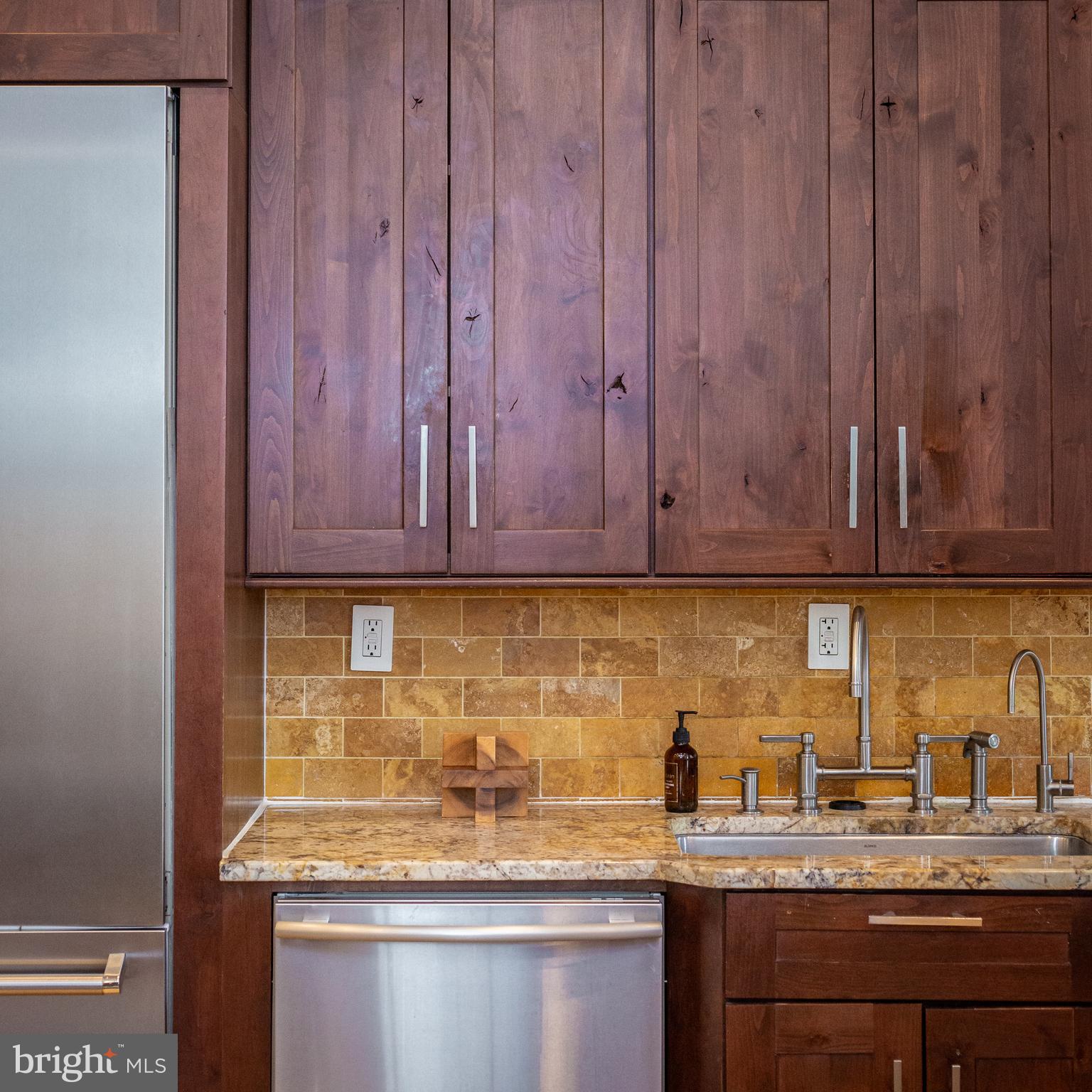 1311 Riggs Street Northwest Washington, DC 20009 - Photo 20 of 101 a kitchen with granite countertop stainless steel appliances a sink window and cabinets