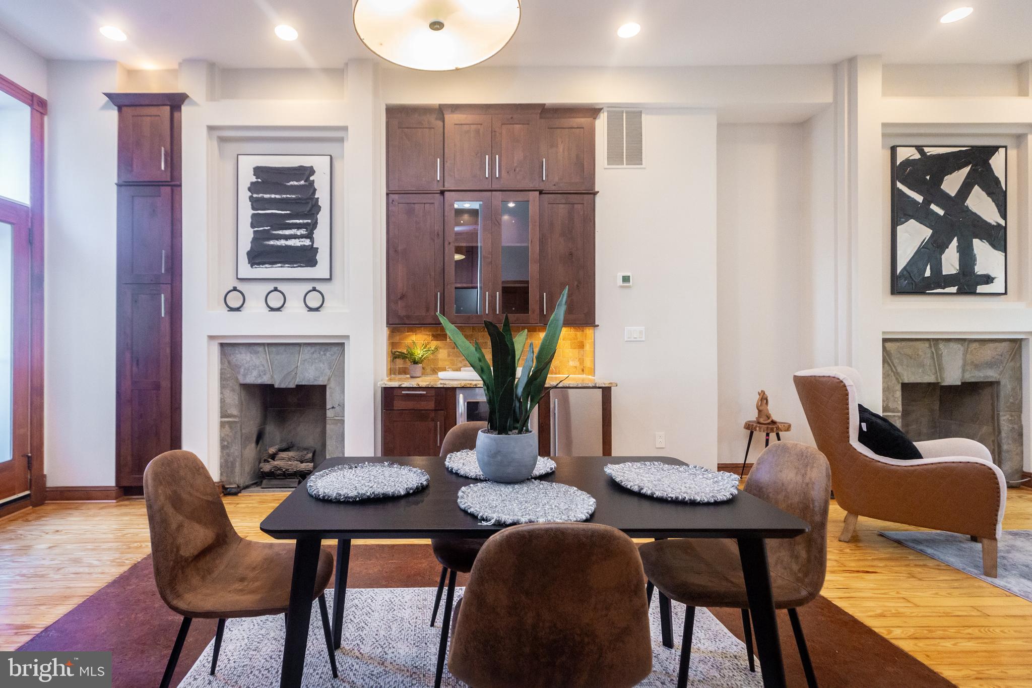 1311 Riggs Street Northwest Washington, DC 20009 - Photo 21 of 101 a view of a dining room with furniture a fireplace and wooden floor