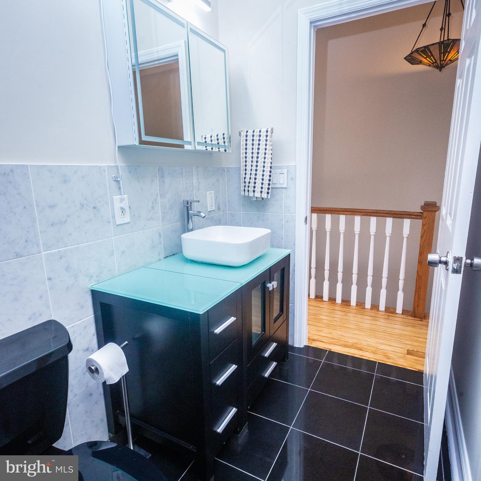 1311 Riggs Street Northwest Washington, DC 20009 - Photo 55 of 101 a bathroom with a sink toilet and mirror