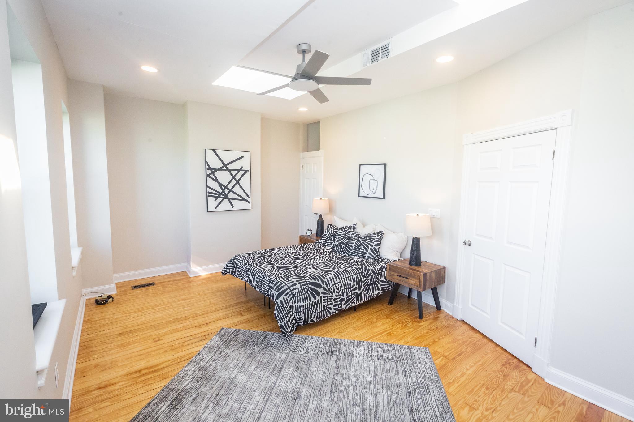 1311 Riggs Street Northwest Washington, DC 20009 - Photo 56 of 101 a bedroom with a bed and a chandelier