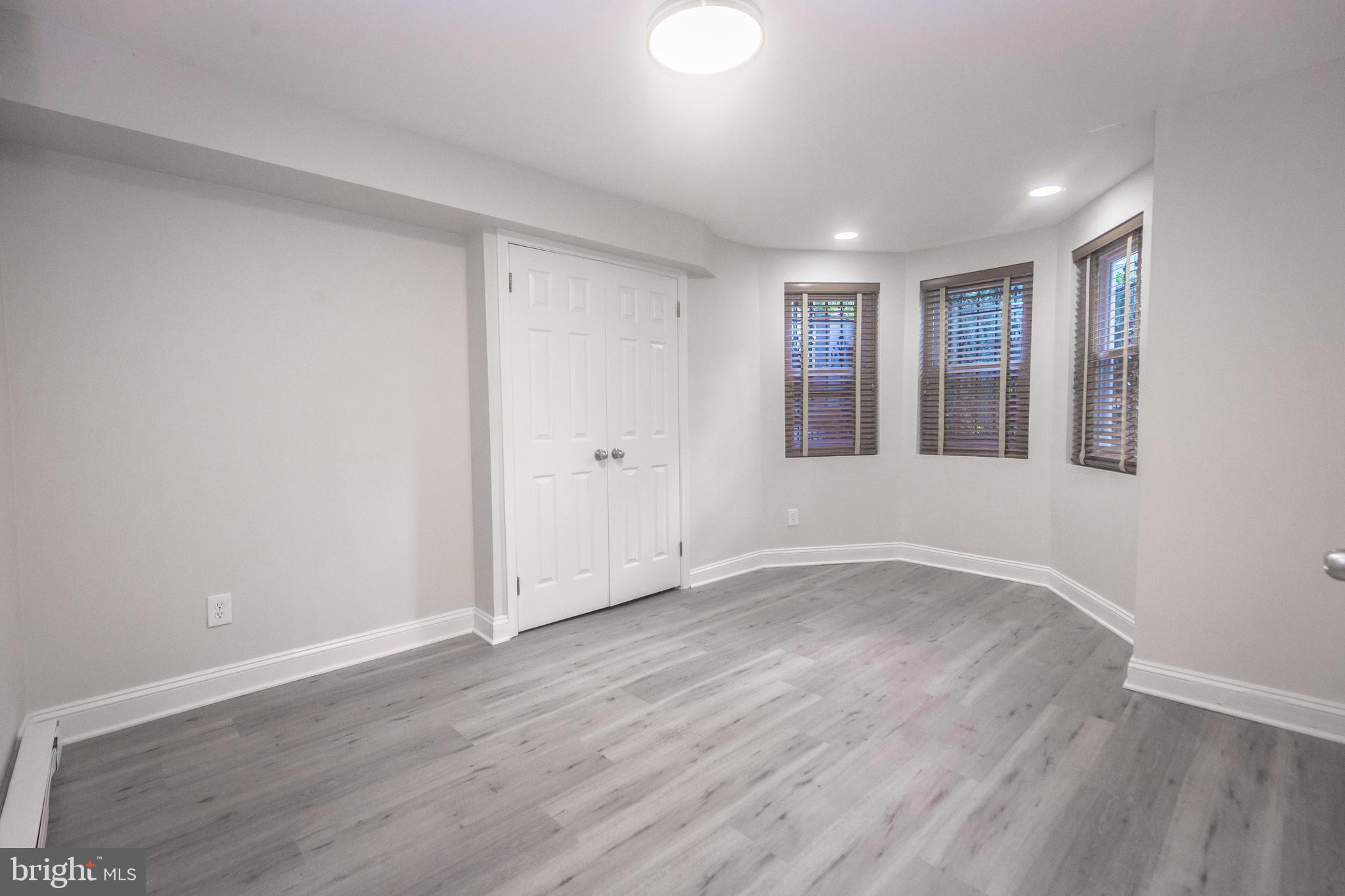 1311 Riggs Street Northwest Washington, DC 20009 - Photo 62 of 101 a view of an empty room with wooden floor