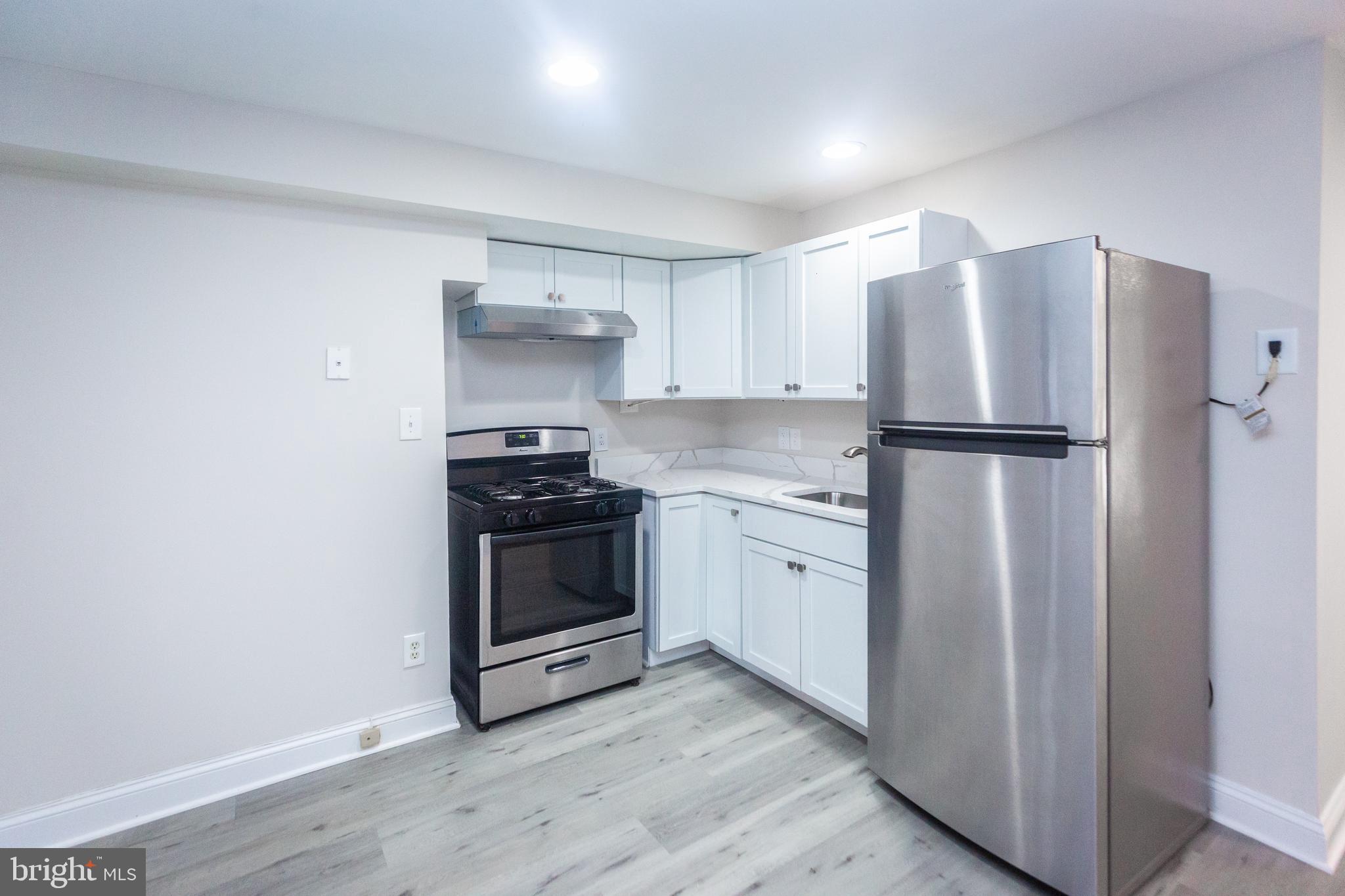 1311 Riggs Street Northwest Washington, DC 20009 - Photo 68 of 101 a kitchen with a refrigerator sink and stove