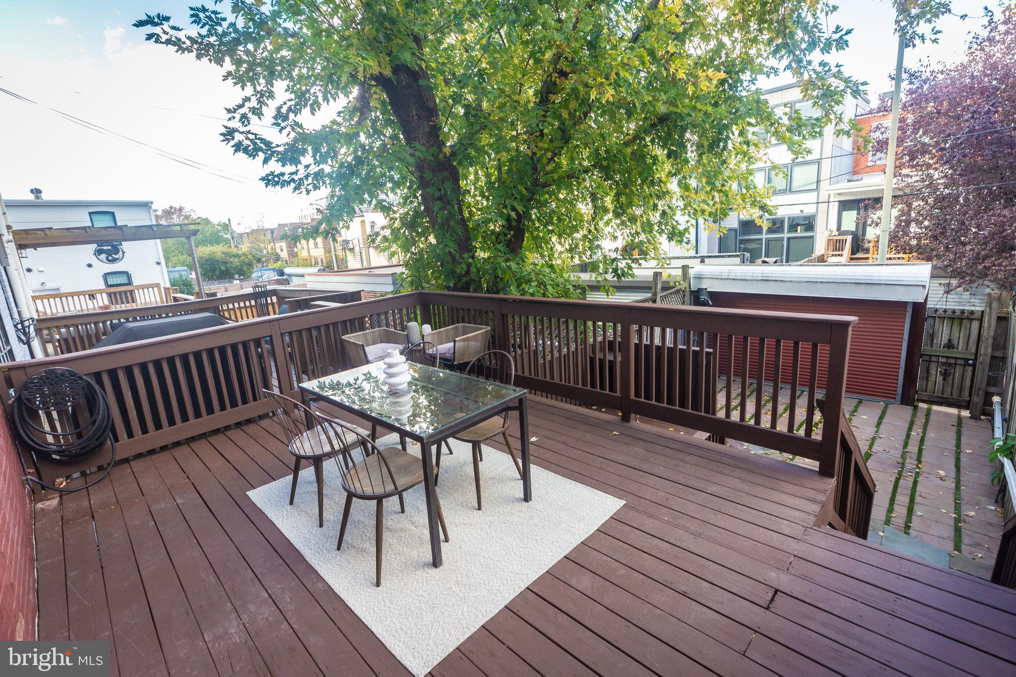 1311 Riggs Street Northwest Washington, DC 20009 - Photo 74 of 101 a view of a deck with wooden floor and outdoor seating