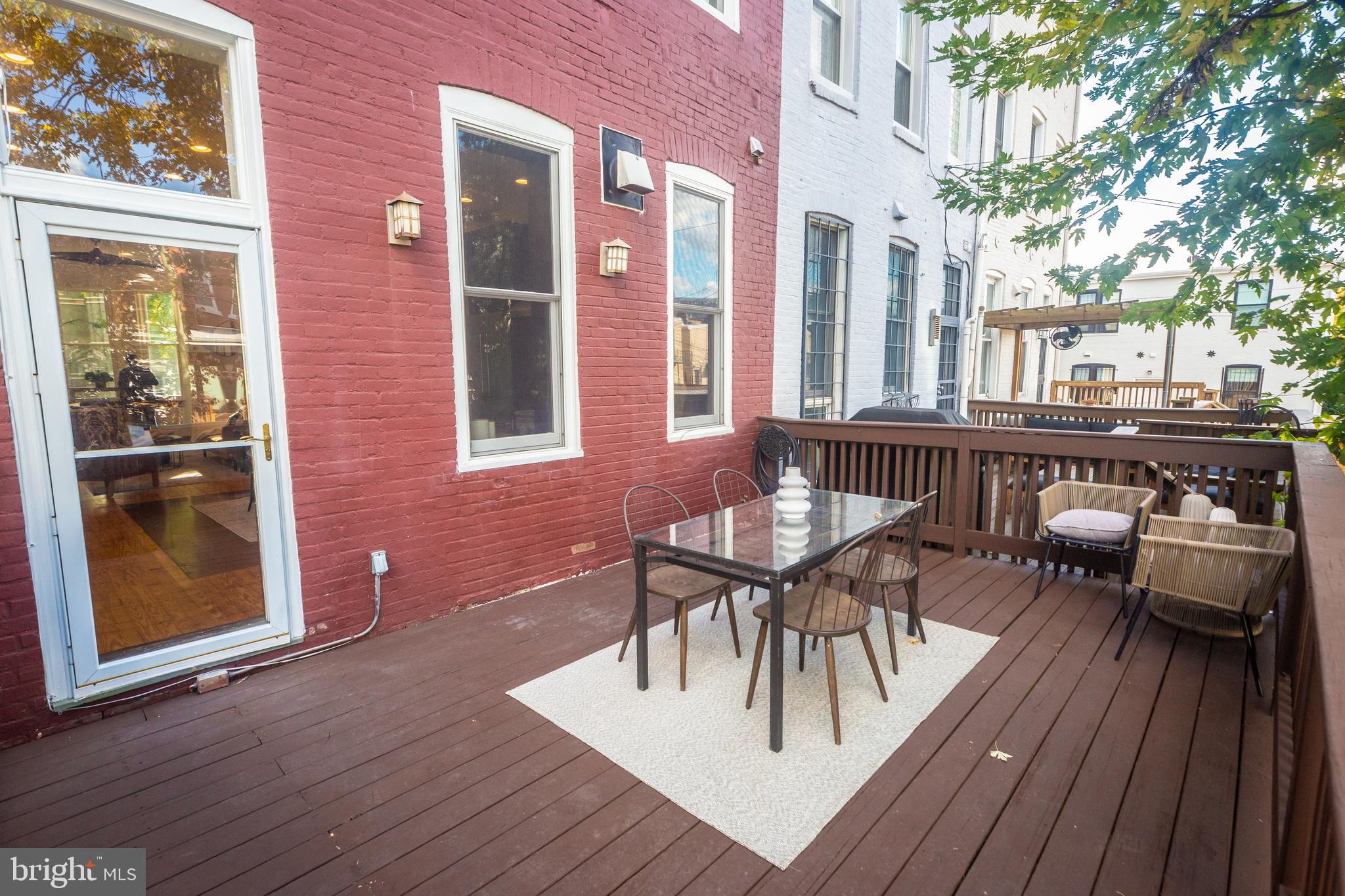 1311 Riggs Street Northwest Washington, DC 20009 - Photo 75 of 101 a view of a patio with table and chairs and wooden floor