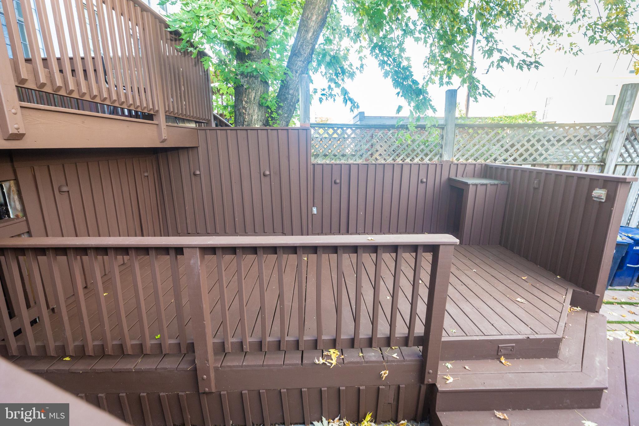 1311 Riggs Street Northwest Washington, DC 20009 - Photo 78 of 101 a view of deck with wooden fence and large trees
