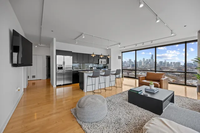 a living room with furniture and floor to ceiling windows