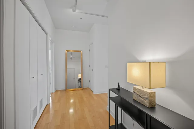 a bedroom with a bed and large window