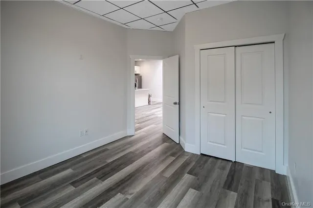 a view of a room with wooden floor