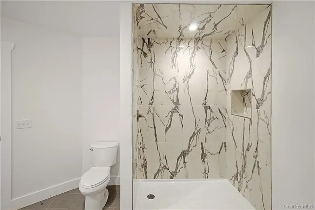 a bathroom with a toilet and a shower curtain