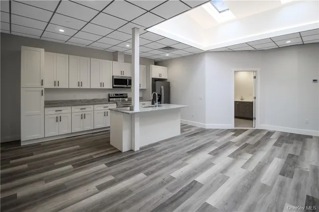 a kitchen with stainless steel appliances granite countertop a stove a sink and a refrigerator