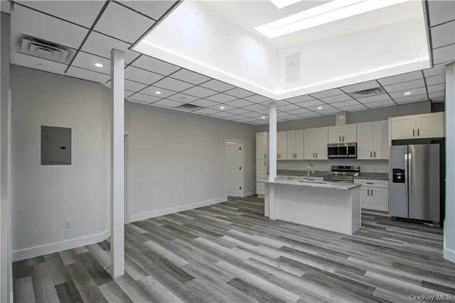 a view of a kitchen with a sink stainless steel appliances and cabinets