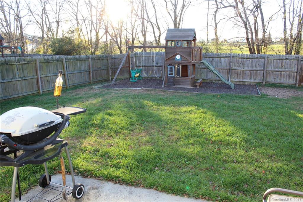 164 Wildbriar Road Fletcher, NC 28732 - Photo 15 of 16 a backyard of a house with table and chairs