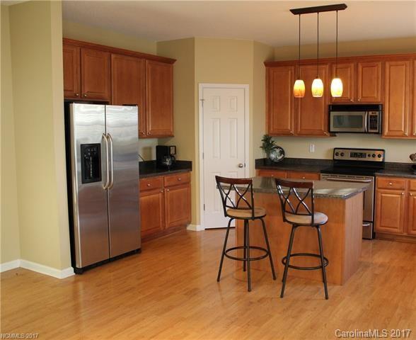 164 Wildbriar Road Fletcher, NC 28732 - Photo 5 of 16 a kitchen with stainless steel appliances a refrigerator a stove a sink and chairs
