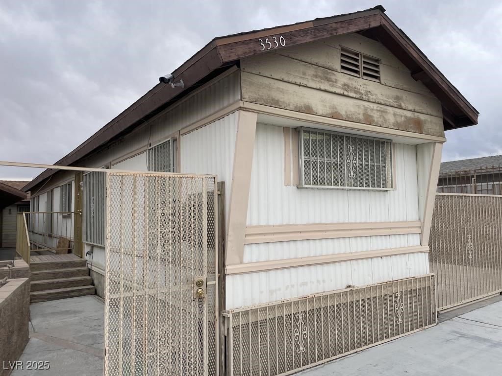 3530 North Pecos Road Las Vegas, NV 89115 - Photo 4 of 46 View of side of home with fence