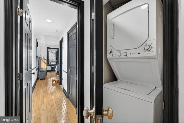 a view of a hallway with a washer and dryer