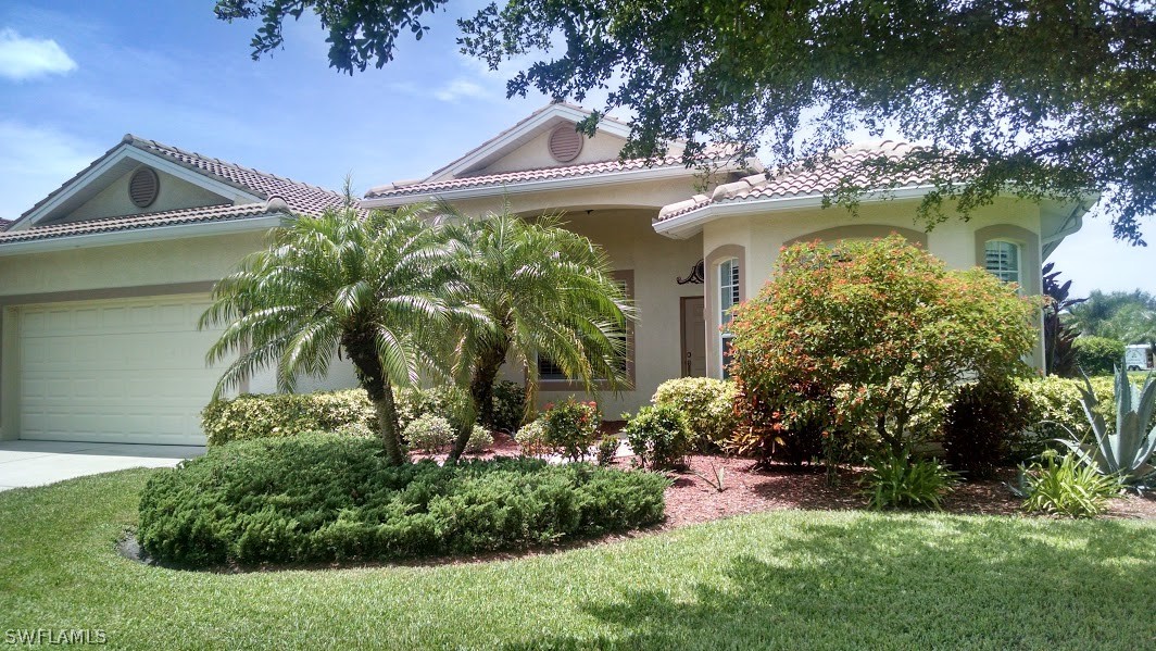 4629 Fairloop Run Lehigh Acres, FL 33973 - Photo 1 of 24 a view of a house with a yard and a lawn chair