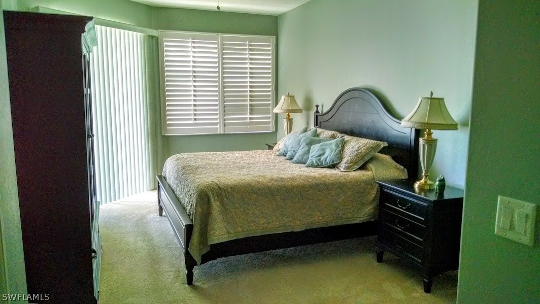 4629 Fairloop Run Lehigh Acres, FL 33973 - Photo 7 of 24 a bedroom with a bed and a painting on the wall