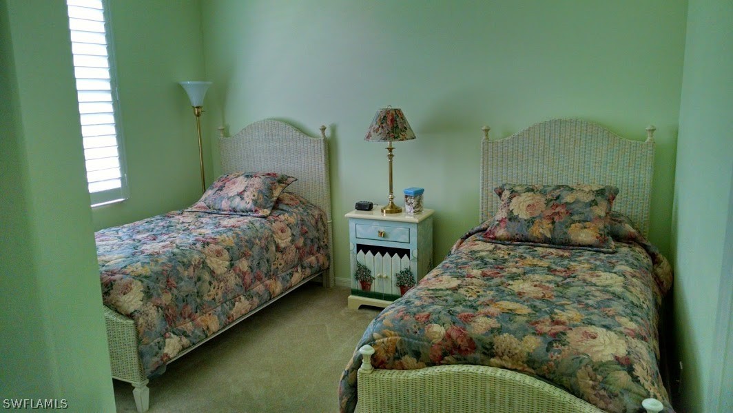 4629 Fairloop Run Lehigh Acres, FL 33973 - Photo 8 of 24 a bedroom with two beds and a window