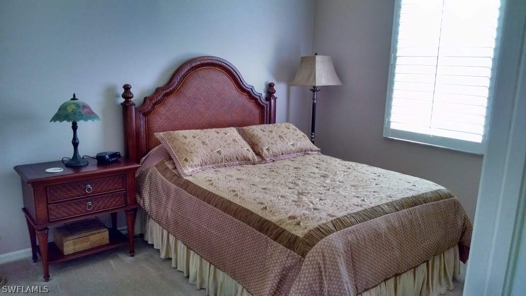4629 Fairloop Run Lehigh Acres, FL 33973 - Photo 9 of 24 a bedroom with a bed and a dresser