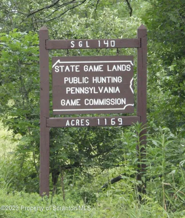 a sign broad in front of red brick house