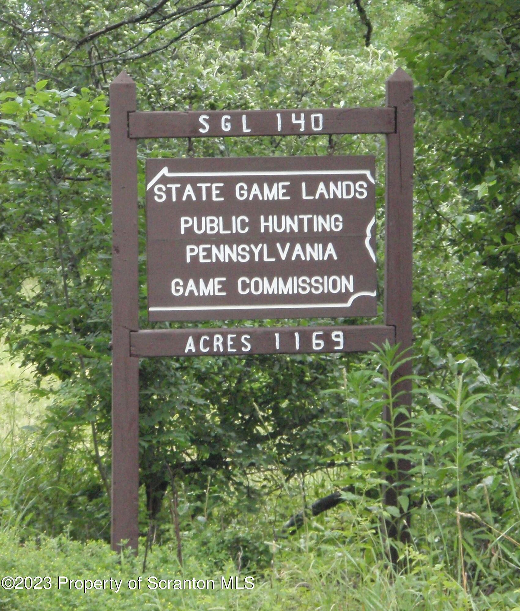 a sign broad in front of red brick house