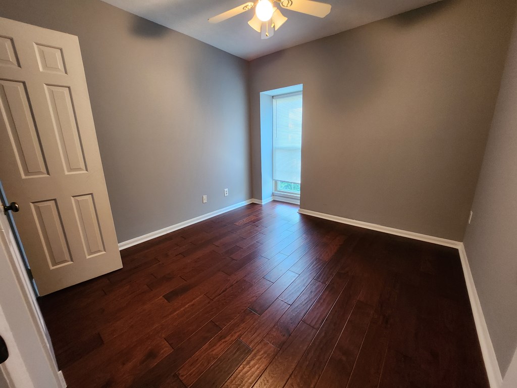 1255 Cedar Avenue, Unit 4 Columbus, GA 31906 - Photo 18 of 21 an empty room with wooden floor and windows