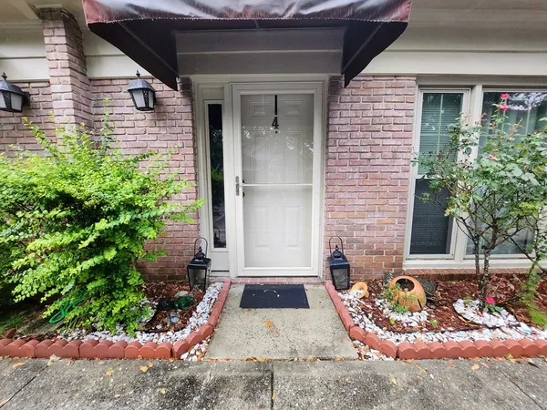 a front view of a house with garden