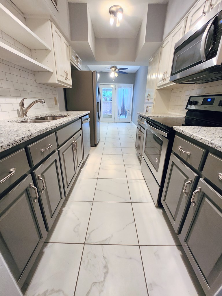 1255 Cedar Avenue, Unit 4 Columbus, GA 31906 - Photo 6 of 21 a kitchen with granite countertop a sink a stove and cabinets