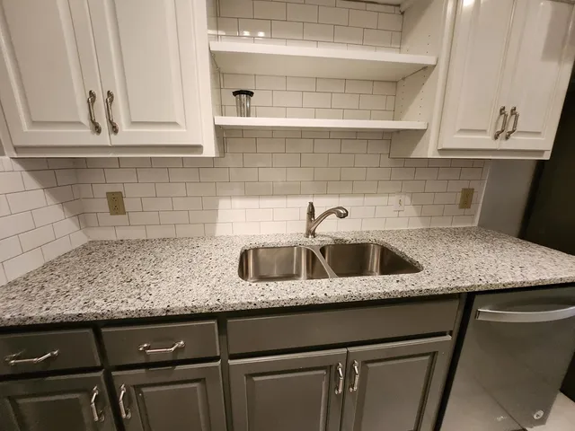 a kitchen with a sink and cabinets