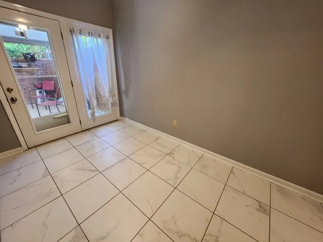 a view of an empty room and a window